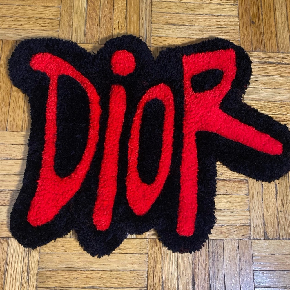 Custom black and red luxury-style door mat — hand-tufted